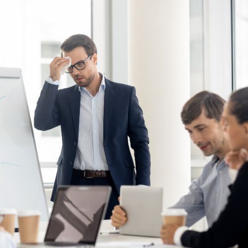 Someone experiencing severe stress while presenting, searching for methods to manage and overcome anxiety.